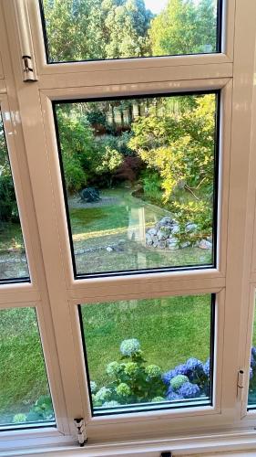 a view from a window of a garden at The Cliffs - A Pedrinha in Viveiro