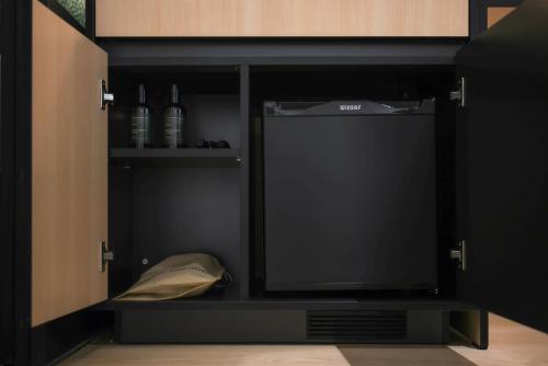 a black cabinet with a television in it at Mitasuya Ryokan Hotel Gumi by AanK in Gumi