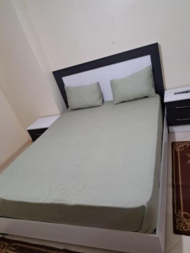 a bed in a room with two pillows on it at شقة مفروشة سلوان ليلى in Selouane
