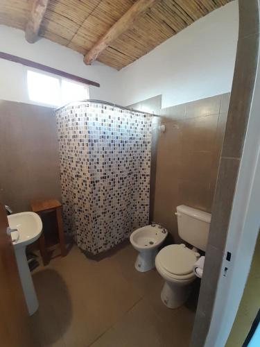 ein Badezimmer mit zwei Toiletten und einem Waschbecken und einer Dusche in der Unterkunft Cabaña de campo Triasico in Banda Florida