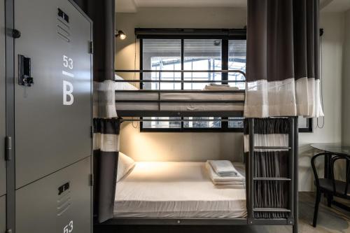 a couple of bunk beds in a room at Stay Wanglang in Bangkok