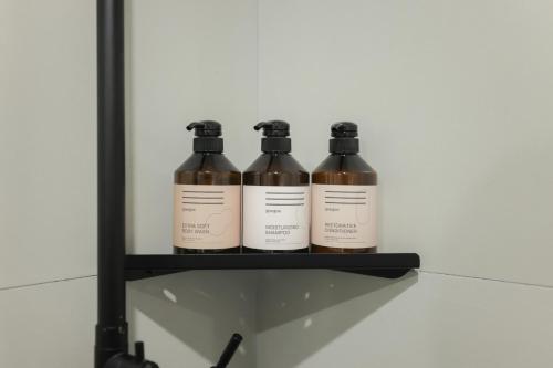 three bottles of wine sitting on a shelf at Time Terminal Hotel Daejeon 2nd by AanK in Daejeon