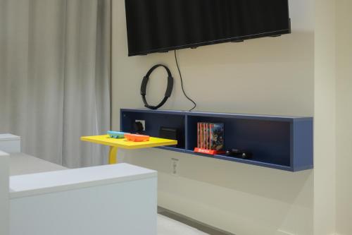 a room with a tv on a wall with a table at Time Terminal Hotel Daejeon 2nd by AanK in Daejeon