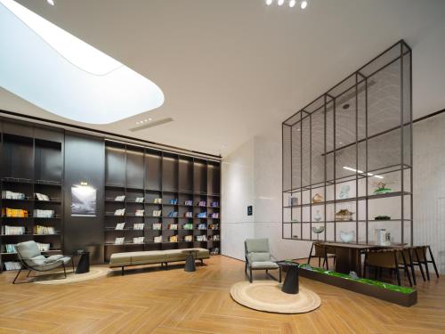 a room with a table and chairs and a large window at Atour Hotel Zhengzhou Erqi Plaza David City in Zhengzhou