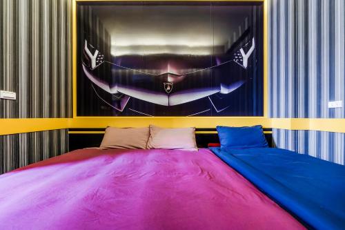 a bedroom with a large bed with colorful sheets at Happiness Romantic B&B in Donggang
