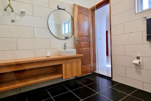 a bathroom with a sink and a mirror at Paris in Lomé