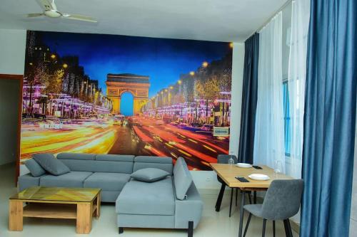 a living room with a large painting of a city at Paris in Lomé