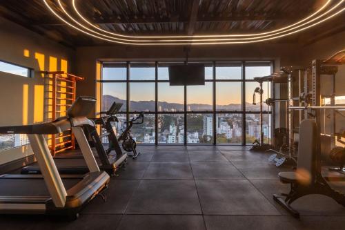 a gym with a view of the city at LOFT UP 1309 | Mobiliado | WIFI | Piscina | in Blumenau