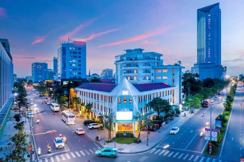 a busy city street with cars on the road at ÊMM Hotel Hue in Hue