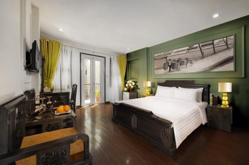 a bedroom with a large bed and a sink at Sena Boutique Hotel & Travel in Hanoi