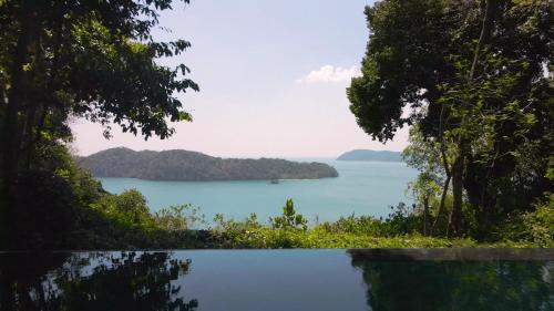 a view of a body of water with trees at Ambong Pool Villas - Private Pool in Pantai Cenang