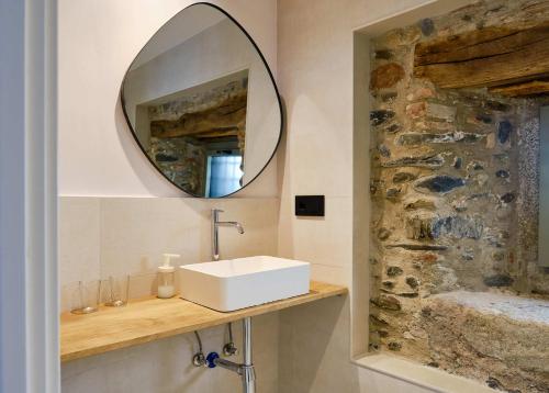 a bathroom with a sink and a mirror at Hotel Molí Cardedeu in Cardedeu
