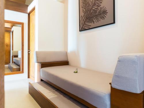 a small room with a bed and a chair at Baan Puri - SHA Extra Plus in Lipa Noi