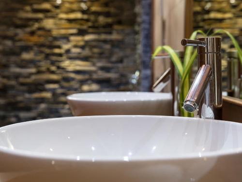 a sink with a faucet in a bathroom at Baan Puri - SHA Extra Plus in Lipa Noi