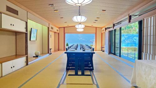 a large room with a long table with chairs at Ryuguden in Hakone
