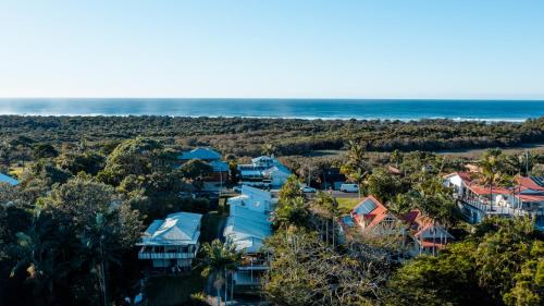 an aerial view of a house with the ocean in the background at Tallows House on Paterson in Byron Bay