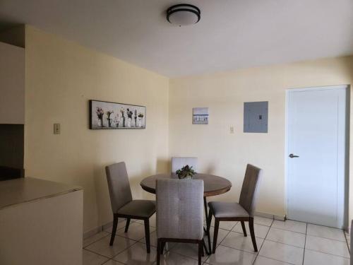 a dining room with a table and chairs at Stargaze Comfort Under the Stars & Arcade Room in Aguadilla