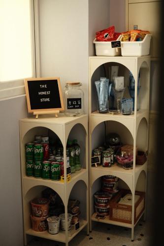 two shelves with food and drinks in a pantry at 運河十六 海港景觀整層主臥房Canal16 HarborView Studio in Tainan