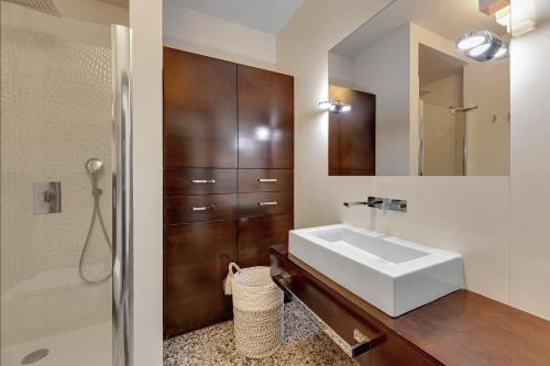 a bathroom with a sink and a mirror at Willa Morska Deluxe by Grand Apartments in Sopot