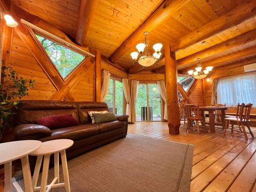 a living room with a couch and a dining room at Haus Yuki in Hakuba