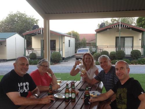 a group of people sitting at a table with drinks at Albury Holiday Park in Albury