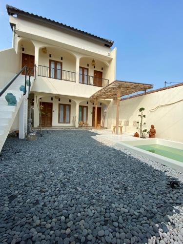 a villa with a swimming pool and a house at Sastro Place in Yogyakarta