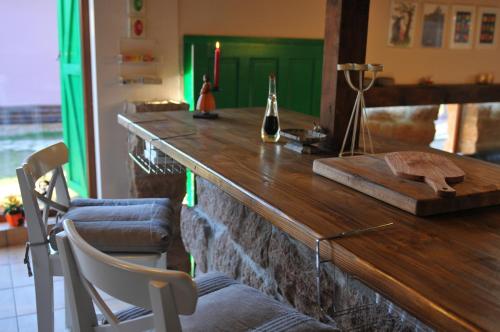 a bar with a wooden counter with two chairs at Villa Kada in Belogradchik
