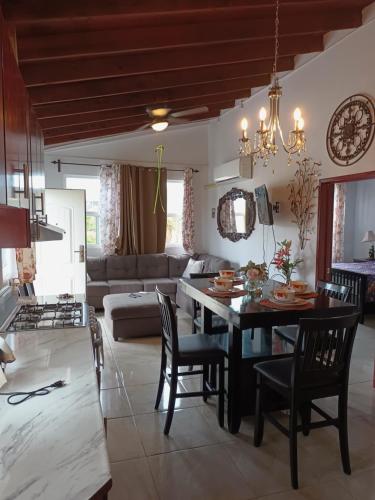 a kitchen and living room with a table and chairs at Apartamentos Rosarito.!! Con Vista al Mar ! in Rosarito