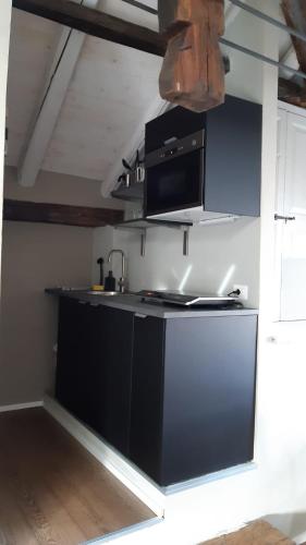 a kitchen with a sink and a stove at DomasHome in Domaso