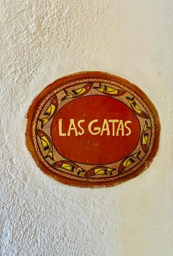 a sign on a ceiling with the name las cats at Ensueño de Fuga in Zihuatanejo