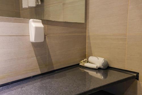 a bathroom with a hair dryer on a counter at From H The Best Hotel Jeju Seongsan in Seogwipo