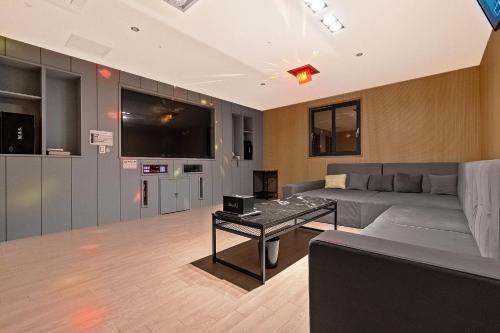 a living room with a couch and a table at Pohang A1Hotel Haedo in Pohang