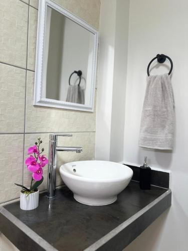 a bathroom with a white sink and a mirror at El Mirador A2 in Santa Rosa de Copán