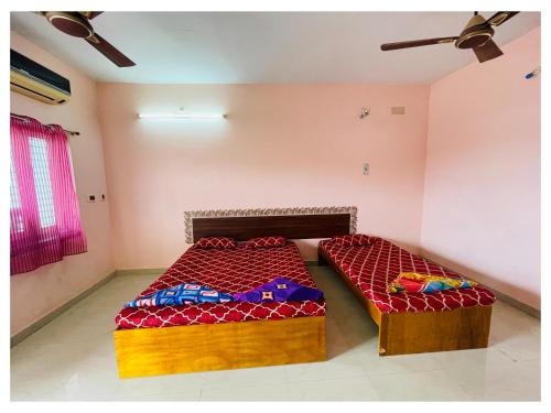 a room with two beds in a room at THIRUNALLAR S A RESIDENCY in Thirunallar