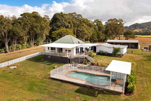 an aerial view of a house with a swimming pool at 'Rail Trail Cottage'-Artisan rural Home 5 mins to pristine beach in Mooball