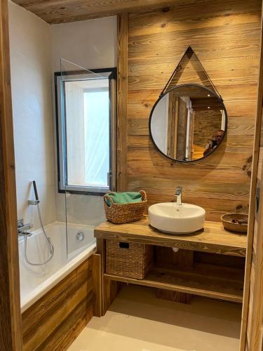 a bathroom with a sink and a mirror at Un Écrin de Sérénité Face aux Montagne chalet nathalya in Vars