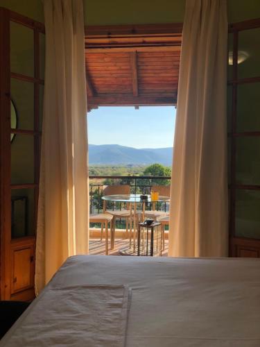 a bedroom with a bed and a view of a balcony at Annie's sweet home Paralio Astros in Paralion astros
