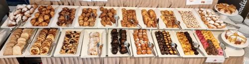 a bunch of different types of food on a table at Hotel Mediterraneo in Lignano Sabbiadoro