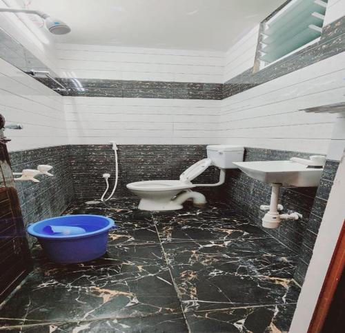 a bathroom with a toilet and a sink at Minnal Residency in kāraikāl