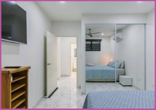a bedroom with a bed and a sliding glass door at Luxe On Duke in Stuart Park