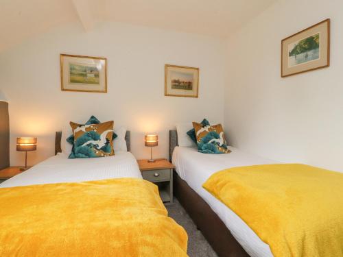 En eller flere senge i et værelse på Stork Cottage