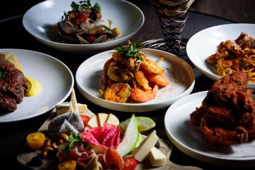 a group of plates of food on a table at Hotel Proverbs Taipei in Taipei