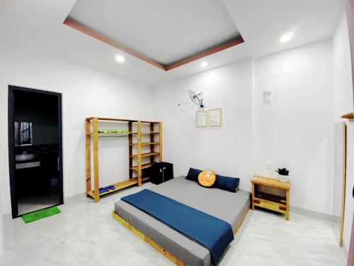 a bedroom with a bed and a book shelf at The Sweet Home in Nha Trang