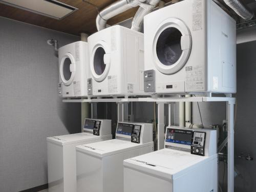 a row of washers and dryers on a shelf at Gran Palette Hakodate in Hakodate