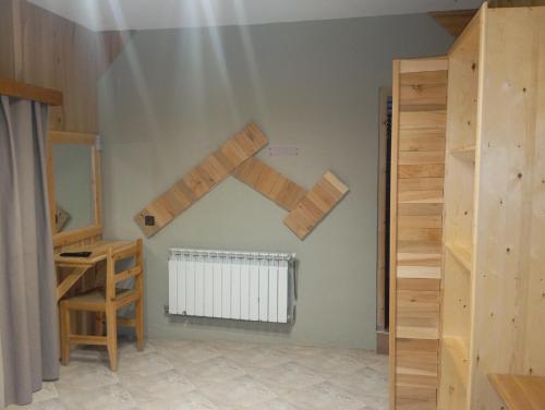 a room with wooden shelves and a staircase at Le Gite du Barrage in Zaouia Ben Smine