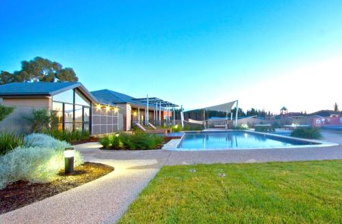 a house with a swimming pool in a yard at Club Wyndham Seven Mile Beach, Trademark Collection by Wyndham in Cambridge