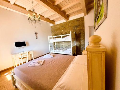a bedroom with a large bed and a desk at Nonna Nara Bed & Breakfast in Grosseto