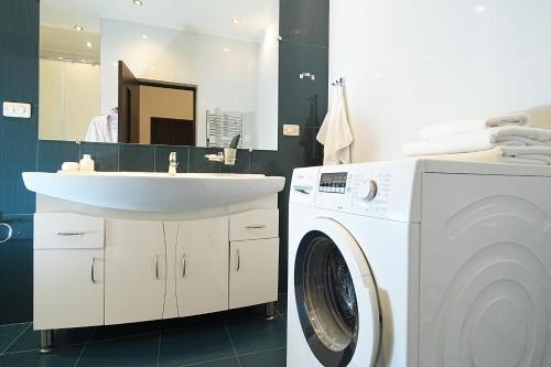 a bathroom with a washing machine and a sink at Sweet Home Apart-Hotel in Yerevan