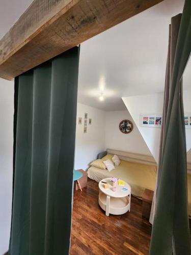a living room with a couch and a table at Séjour idyllique normand in Veules-les-Roses