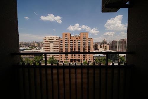 a view of a city skyline from a balcony at Sweet Home Apart-Hotel in Yerevan